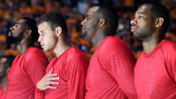 L.A. Clippers players stand on the court during the National Anthem before Game 4 of the NBA Western Conference playoffs in Oakland.