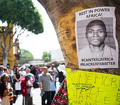 A crowd gathers in L.A.'s skid row for a memorial for Charly Leundeu Keunang, who was shot and killed by LAPD officers during a March 1 confrontation. 