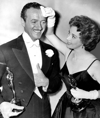 Susan Hayward wipes the brow of fellow winner David Niven.