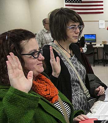 Shelly Walston, left, and Mallory Rine swear their information is correct as they pick up their marriage license application at the Sedgwick County Courthouse in Wichita, Kan.