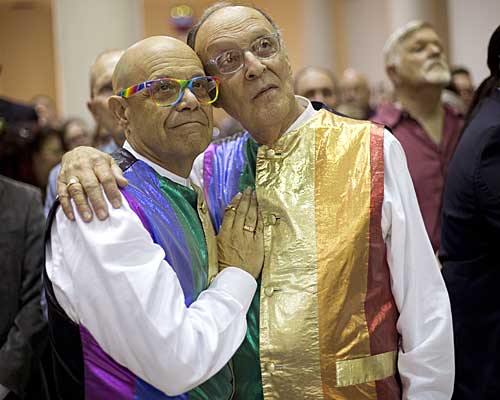 John and Shel Goldstein hug during a group wedding in Delray Beach, Fla. 