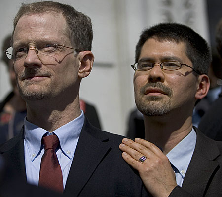 John Lewis, left, and Stuart Gaffney listen at a news conference about hearing on same-sex unions.