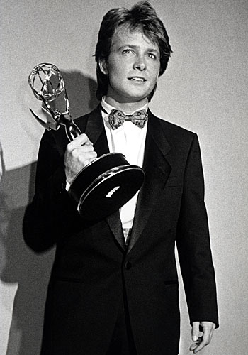 Michael J. Fox shows off his actor award for "Family Ties."