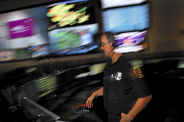 LAFD dispatcher Steve Bloch talks with a colleague about a call.