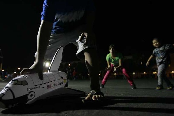 Children at play after dark at Exposition Park.