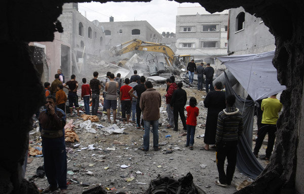 Palestinian firefighters work at the scene of an Israeli air strike on a building in the Jebaliya refugee camp in the northern Gaza Strip.