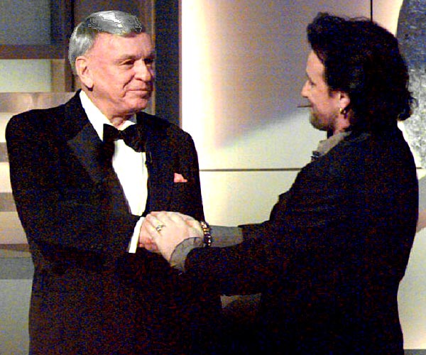 Frank Sinatra is congratulated by Bono, lead singer of the group U2, after Sinatra is honored with a Lifetime Achievement Award at the 36th Grammy Awards in 1994.